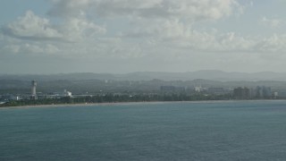 4.8K aerial stock footage of Luis Muñoz Marín International Airport seen from Caribbean blue ocean waters, Puerto Rico Aerial Stock Footage | AX103_145