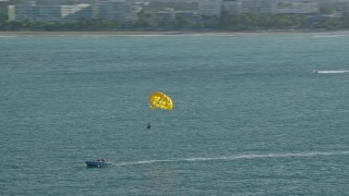 4.8K aerial stock footage Parasailing in Caribbean blue waters, San Juan, Puerto Rico Aerial Stock Footage | AX103_146