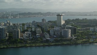 4.8K aerial stock footage of apartment buildings by Caribbean blue waters, San Juan, Puerto Rico Aerial Stock Footage | AX103_151E