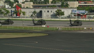 4.8K aerial stock footage of Military helicopters at Isla Grande Airport, San Juan Aerial Stock Footage | AX103_154