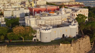 AX104_031E - 4.8K aerial stock footage of La Fortaleza, Old San Juan sunset