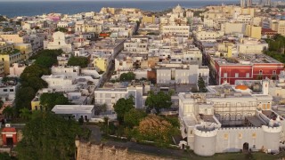 AX104_039E - 4.8K aerial stock footage of La Fortaleza and neighboring buildings, Old San Juan, Puerto Rico, sunset