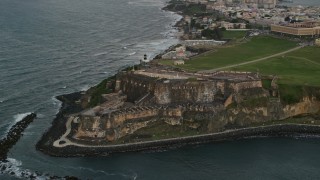 4.8K aerial stock footage of Fort San Felipe del Morro and Caribbean blue ocean waters, Old San Juan, twilight Aerial Stock Footage | AX104_086E