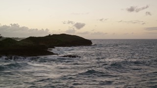 AX104_120E - 4.8K aerial stock footage of the ocean and rugged Caribbean coast, Dorado, Puerto Rico, twilight