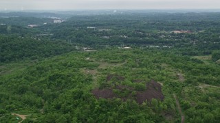 4.8K aerial stock footage of dirt roads on a green hill, Penn Hills, Pennsylvania Aerial Stock Footage | AX105_001