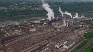 AX105_009E - 4.8K aerial stock footage approaching U.S. Steel Mon Valley Works Factory, Braddock, Pennsylvania