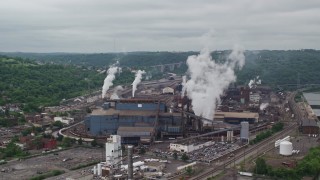 AX105_013E - 4.8K aerial stock footage orbiting U.S. Steel Mon Valley Works Factory, Braddock, Pennsylvania