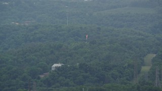 4.8K aerial stock footage of a flame spout and green trees, West Mifflin, Pennsylvania Aerial Stock Footage | AX105_021