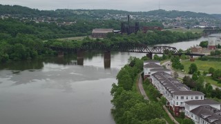 AX105_029E - 4.8K aerial stock footage of Railroad Bridge near Factory, Carrie Furnace, Pittsburgh, Pennsylvania