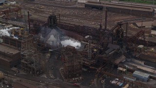 AX105_058E - 4.8K aerial stock footage orbiting U.S. Steel Mon Valley Works Factory, Braddock, Pennsylvania