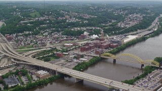 4.8K aerial stock footage flying over bridges toward HJ Heinz Plant, Pittsburgh, Pennsylvania Aerial Stock Footage | AX105_138E