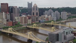 AX105_153E - 4.8K aerial stock footage of bridges spanning river, Downtown Pittsburgh, Pennsylvania