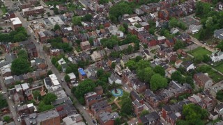 4.8K aerial stock footage flying over town houses and row houses and reveal school, Pittsburgh, Pennsylvania Aerial Stock Footage | AX105_206E