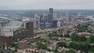 AX105_229E - 4.8K aerial stock footage of Downtown seen from a hill across the river, Downtown Pittsburgh, Pennsylvania