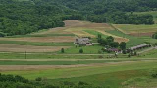 AX106_044E - 4.8K aerial stock footage of a farmhouse and farmland in Beaver Falls, Pennsylvania