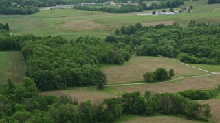 4.8K aerial stock footage of barns, trees, and green fields in Koppel, Pennsylvania Aerial Stock Footage | AX106_050E