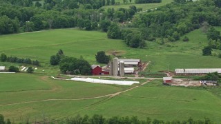 4.8K aerial stock footage of a red barn and silos in Enon Valley, Pennsylvania Aerial Stock Footage | AX106_060