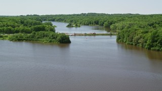 AX106_154E - 4.8K aerial stock footage flying over a reservoir and small bridge in Akron City Reservoir, Chagrin Falls, Ohio