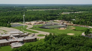 AX106_169E - 4.8K aerial stock footage of a high school with sports fields in Chagrin Falls, Ohio