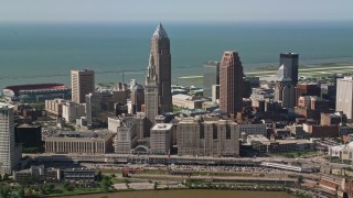 AX107_030E - 4.8K aerial stock footage of Downtown Cleveland skyscrapers and industrial buildings, Ohio