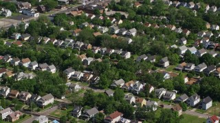 AX107_053 - 4.8K aerial stock footage of suburban homes and trees, Cleveland, Ohio