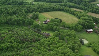 4.8K aerial stock footage flying away from forests to reveal rural homes, Darlington, Pennsylvania Aerial Stock Footage | AX107_122E