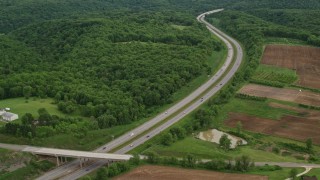 4.8K aerial stock footage of an interstate bordered by forests and farmland, Beaver Falls, Pennsylvania Aerial Stock Footage | AX107_128E