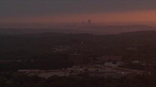 4K aerial stock footage flying by apartment buildings, Penn Hills, Downtown Pittsburgh, sunset Aerial Stock Footage | AX108_003