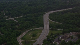 4K aerial stock footage following an interstate through trees, Pittsburgh, Pennsylvania Aerial Stock Footage | AX108_005