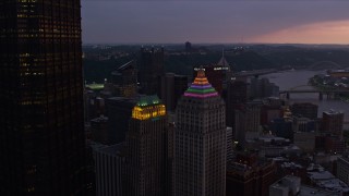 4K aerial stock footage flying by Gulf Tower and U.S. Steel Tower, Downtown Pittsburgh, Pennsylvania, twilight Aerial Stock Footage | AX108_073E