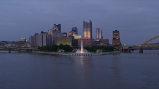 4K aerial stock footage ascending over Point State Park toward Downtown Pittsburgh, Pennsylvania, twilight Aerial Stock Footage | AX108_096E