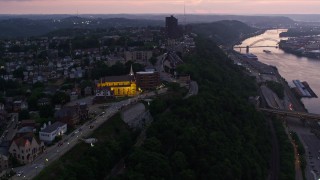 4K aerial stock footage flyby Highmark Stadium, St. Mary of the Mount, suburban homes in Pittsburgh, Pennsylvania, twilight Aerial Stock Footage | AX108_102E