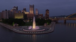 4K aerial stock footage flying by Downtown Pittsburgh skyscrapers revealing Point State Park, Pennsylvania, twilight Aerial Stock Footage | AX108_122E