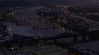 4K aerial stock footage of bridges spanning the Allegheny River near PNC Park, Downtown Pittsburgh, twilight Aerial Stock Footage | AX108_134E