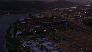 AX108_144E - 4K aerial stock footage approaching Heinz Field, Pittsburgh, Pennsylvania, twilight