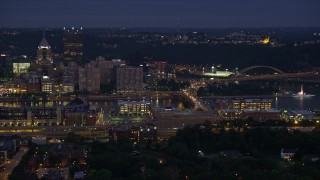 AX108_150E - 4K aerial stock footage flying by Downtown Pittsburgh revealing Point State Park, Pennsylvania, night