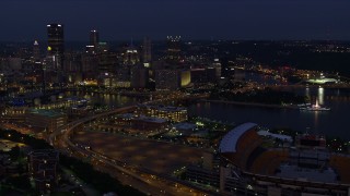 4K aerial stock footage flying toward Downtown Pittsburgh passing Heinz Field, Pennsylvania, night Aerial Stock Footage | AX108_160E