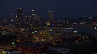 AX108_162E - 4K aerial stock footage of Downtown Pittsburgh seen from the Ohio River, Pennsylvania, night