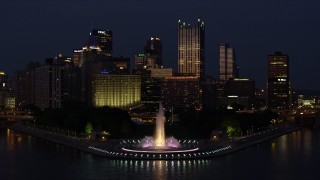 AX108_168E - 4K aerial stock footage flying by Downtown Pittsburgh and Point State Park, Pennsylvania, night