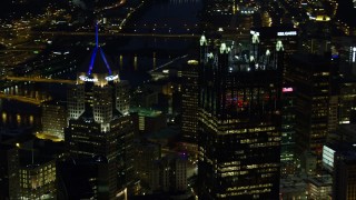 AX108_210E - 4K aerial stock footage approaching PPG Place revealing Fifth Avenue Place, Downtown Pittsburgh, night