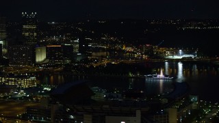 AX108_215E - 4K aerial stock footage of Point State Park and Heinz Field, Pittsburgh, night