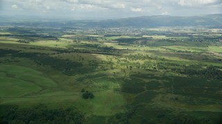 5.5K aerial stock footage approach farms in a green rural landscape, Stirling, Scotland Aerial Stock Footage | AX109_006E