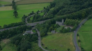 5.5K aerial stock footage of M9 Highway lined with trees, Stirling, Scotland Aerial Stock Footage | AX109_058E