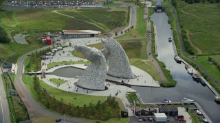 5.5K aerial stock footage of orbiting The Kelpies sculptures with tourists in Falkirk, Scotland Aerial Stock Footage | AX109_124E