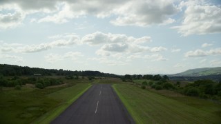 AX110_001E - 5.5K aerial stock footage of green farmland in a rural landscape, Cumbernauld, Scotland