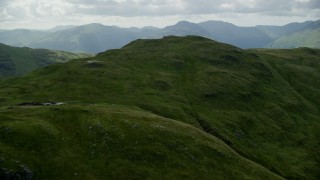 AX110_064E - 5.5K aerial stock footage fly over mountain and reveal Loch Long, Scottish Highlands, Scotland