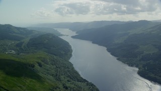 AX110_068E - 5.5K aerial stock footage of Loch Long flowing past lush green mountains, Scottish Highlands, Scotland