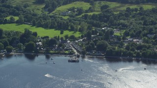 5.5K aerial stock footage orbiting a village on the shores of Loch Lomond, Luss, Scottish Highlands Aerial Stock Footage | AX110_107