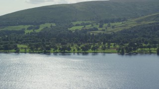 AX110_112 - 5.5K aerial stock footage of a waterfront golf course on Loch Lomond in Luss, Scottish Highlands, Scotland