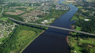 5.5K aerial stock footage of a bird's eye orbit of Erskine Bridge by residential neighborhoods, Glasgow, Scotland Aerial Stock Footage | AX110_144E